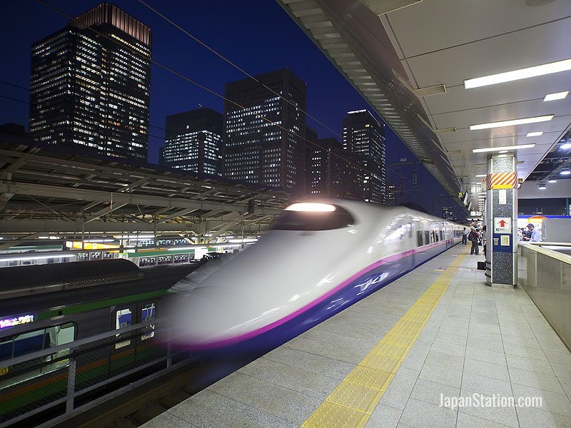 An E2 series Shinkansen train departing from Tokyo Station
