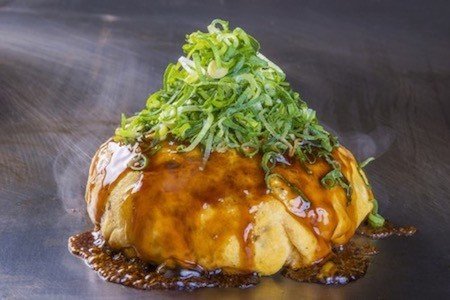 Denko-Sekka’s signature dish is packed with meat, eggs, squid, cheese and topped with spring onions