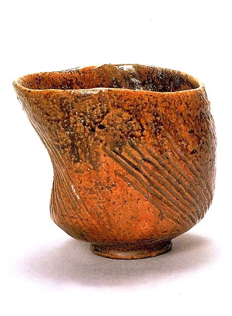 This famous tea bowl by the 1st Ohi Chozaemon is called Hijiri” or Saint.” The rich amber color is typical of Ohi pottery