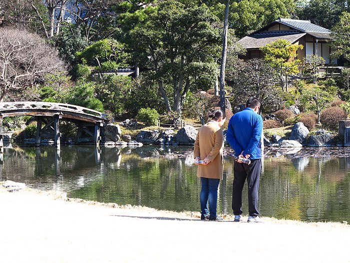 Visitors admiring the pond’s koi carp