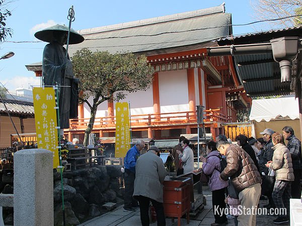 Temple goers pay their respects at the statue of Kukai