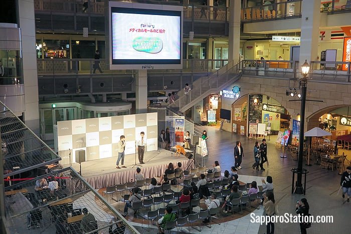 Two comedians entertain shoppers from the Atrium’s event stage
