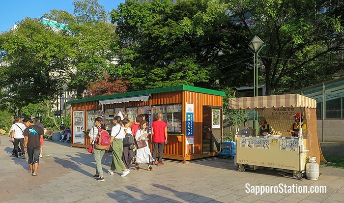 A summer sweetcorn stall set up beside a more permanent takeaway food and refreshment store