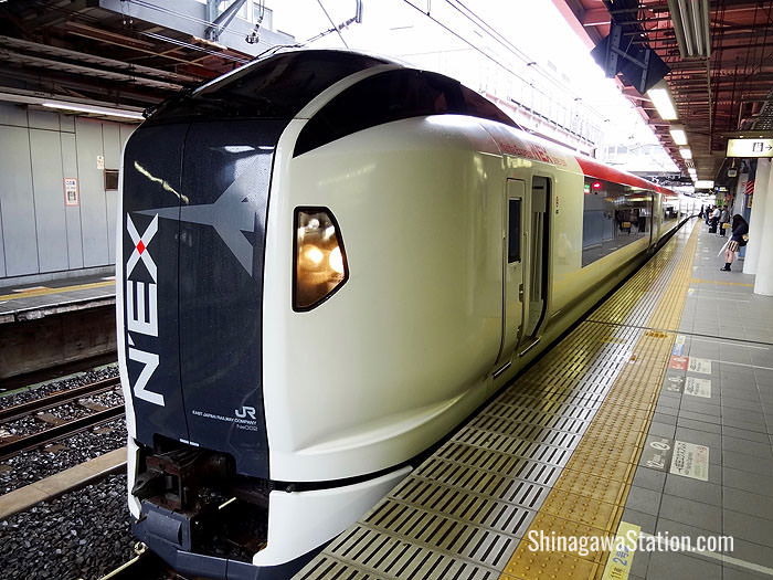 A Narita Express limited express service stops at JR Shinagawa Station