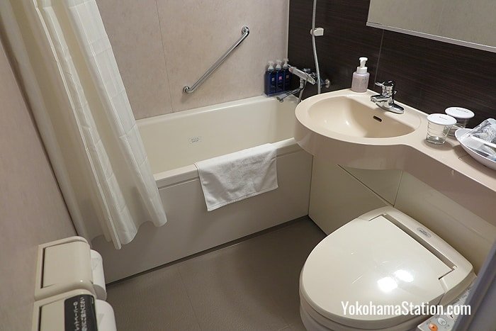 Private bathrooms have showers, bathtubs and toilets with electronic bidets